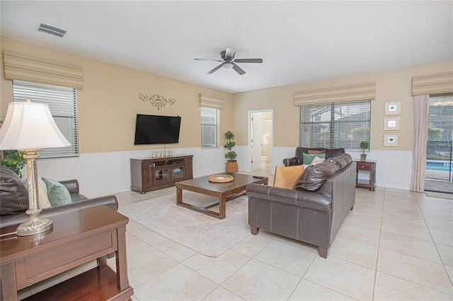 tiled living room with ceiling fan