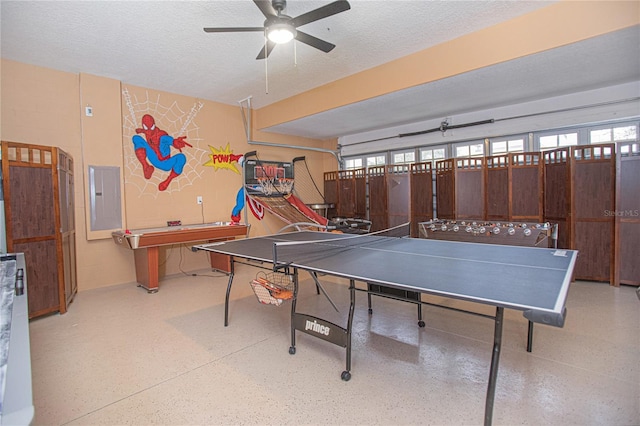 game room with electric panel, a wealth of natural light, ceiling fan, and a textured ceiling