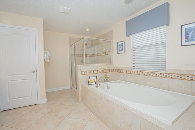 bathroom with tile patterned floors, separate shower and tub, and a textured ceiling