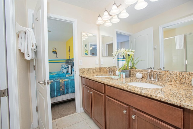 bathroom with tile patterned floors, vanity, and a shower with door