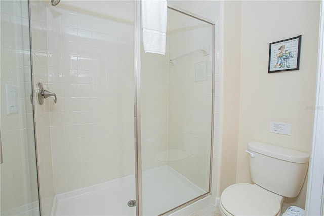 bathroom with walk in shower and toilet