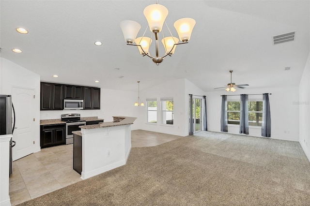 kitchen with ceiling fan with notable chandelier, light colored carpet, stainless steel appliances, and decorative light fixtures