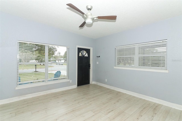 foyer entrance featuring ceiling fan and light wood-type flooring