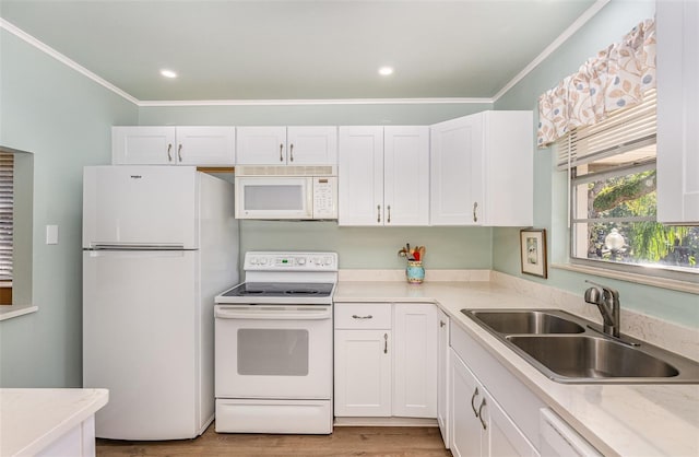 kitchen with white appliances, light hardwood / wood-style flooring, white cabinetry, and sink