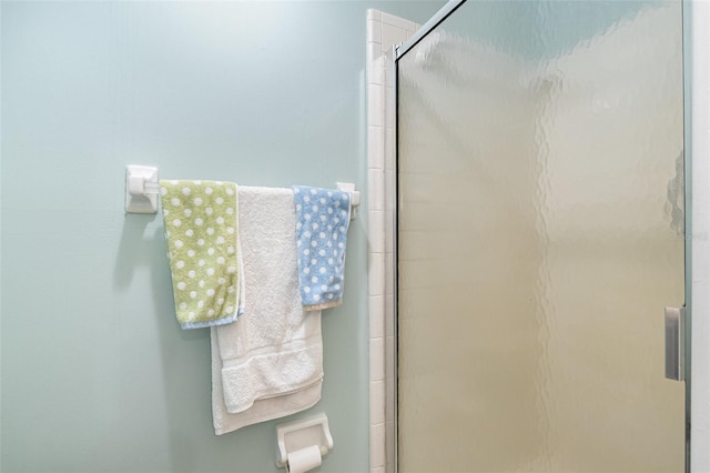 bathroom with a shower with shower door