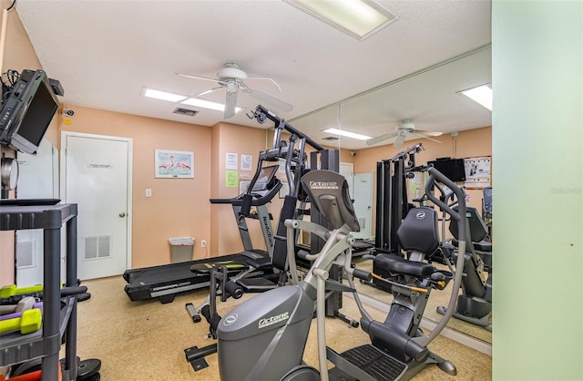 exercise room featuring a textured ceiling and ceiling fan