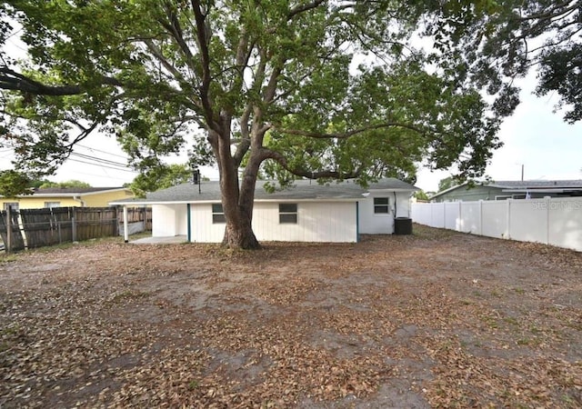 rear view of house featuring cooling unit