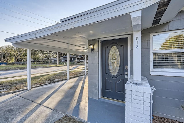 view of exterior entry with a carport