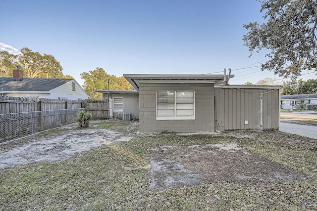 rear view of property featuring cooling unit