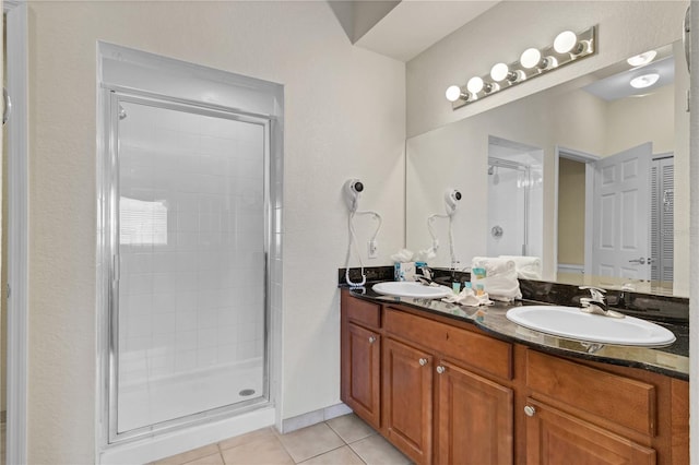 bathroom featuring tile patterned floors, an enclosed shower, and vanity