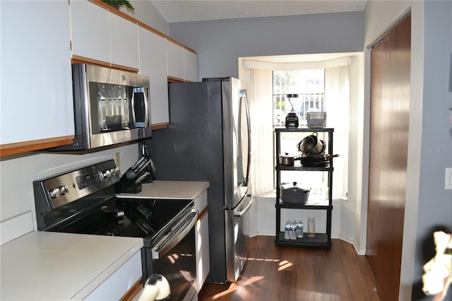 kitchen featuring white cabinetry, dark wood-type flooring, and stainless steel appliances