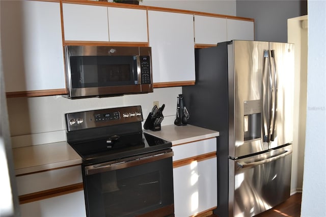 kitchen with white cabinetry and stainless steel appliances