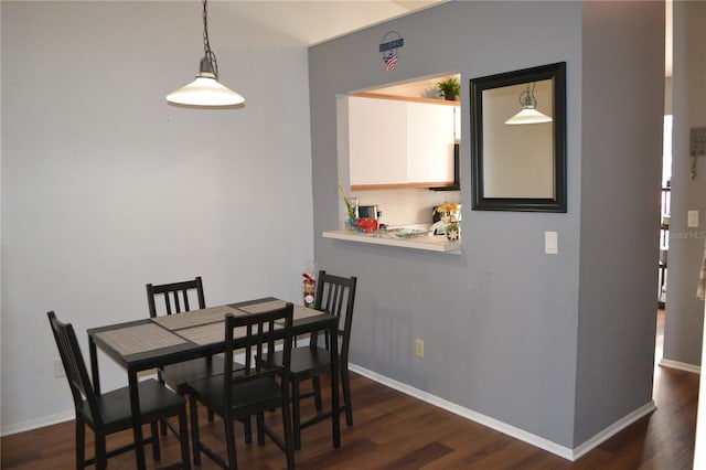 dining space with dark hardwood / wood-style floors