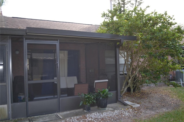 rear view of house featuring a sunroom