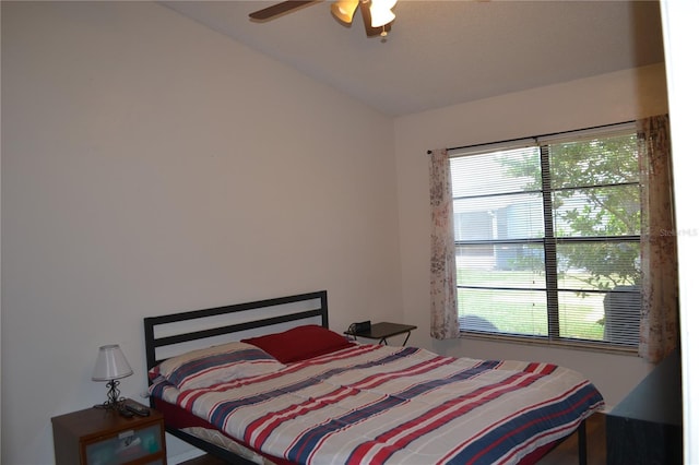 bedroom featuring multiple windows, ceiling fan, and lofted ceiling