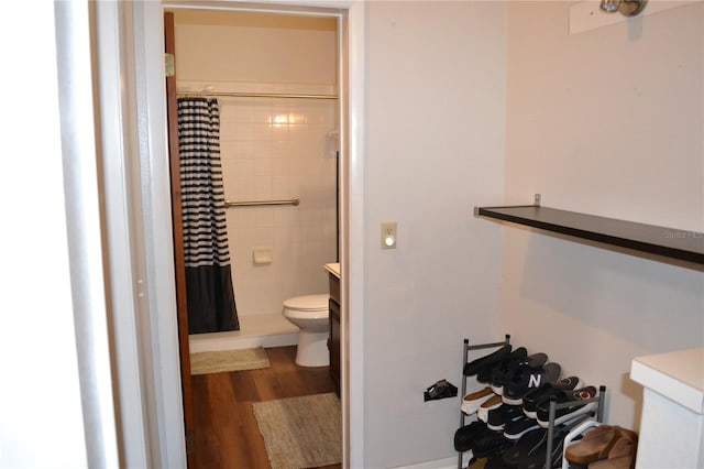 bathroom featuring a shower with curtain, vanity, toilet, and hardwood / wood-style floors