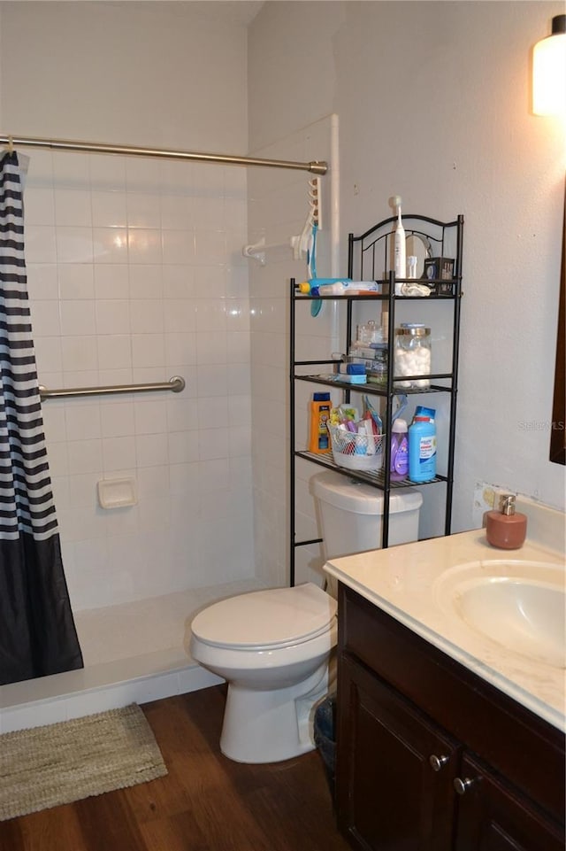 bathroom with a shower with shower curtain, vanity, toilet, and wood-type flooring