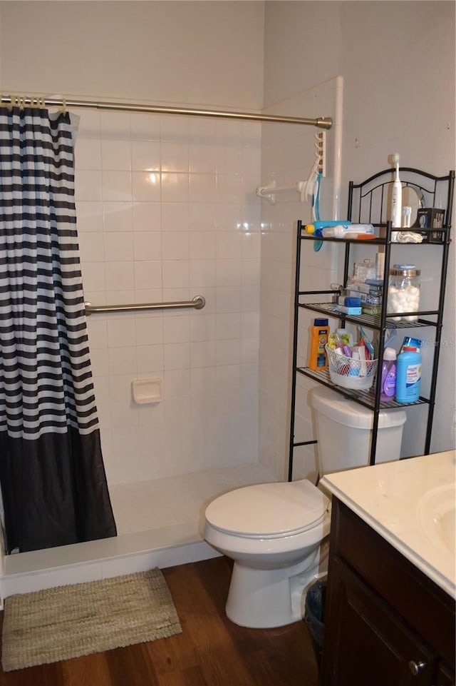 bathroom with vanity, curtained shower, toilet, and wood-type flooring