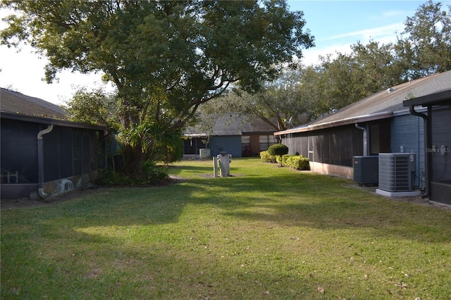 view of yard featuring a sunroom and cooling unit