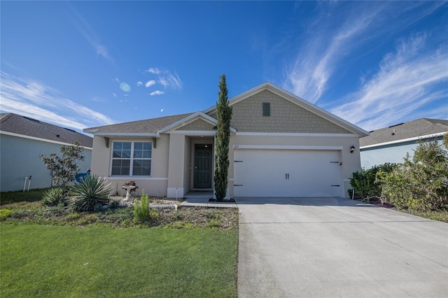 ranch-style house featuring concrete driveway, a garage, a front lawn, and stucco siding