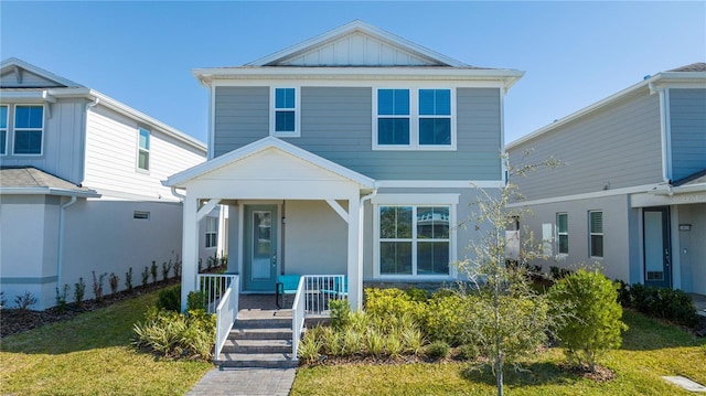 view of front facade featuring a front yard and a porch