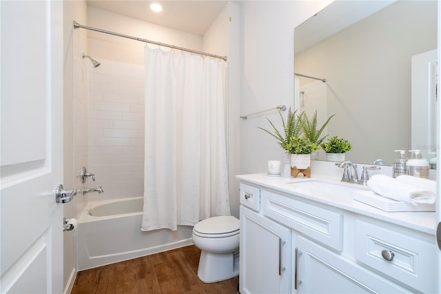 full bathroom with hardwood / wood-style floors, vanity, toilet, and shower / bathtub combination with curtain