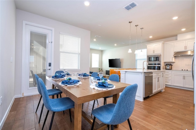 dining room with light hardwood / wood-style floors