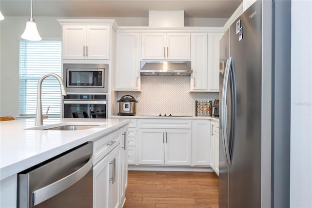 kitchen featuring backsplash, sink, white cabinetry, and stainless steel appliances