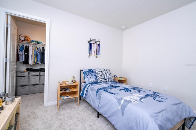 carpeted bedroom featuring a walk in closet and a closet