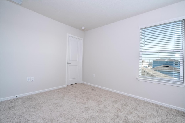 unfurnished room featuring light colored carpet