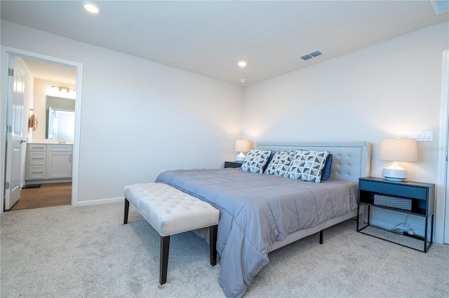 carpeted bedroom featuring ensuite bathroom