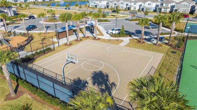 view of basketball court with a water view