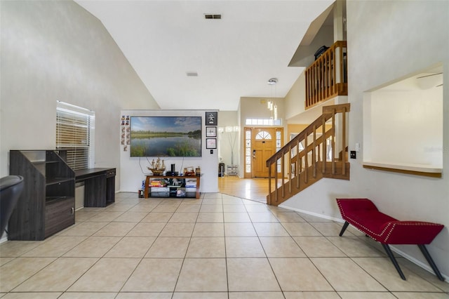 tiled entryway featuring high vaulted ceiling