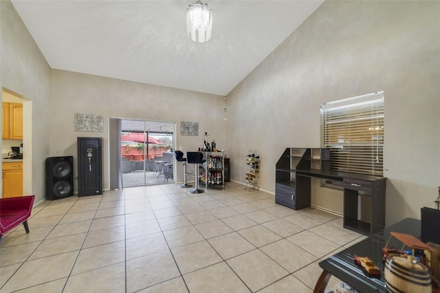 interior space with a towering ceiling and light tile patterned flooring