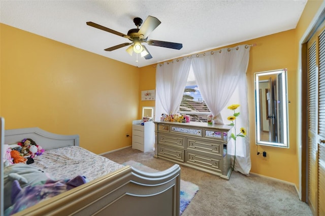 carpeted bedroom featuring a closet and ceiling fan