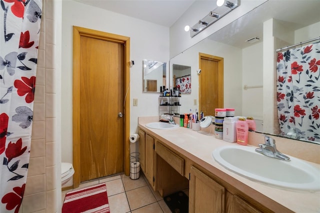 bathroom with tile patterned floors, curtained shower, and vanity