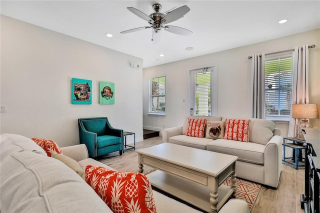 living room with ceiling fan and light hardwood / wood-style flooring