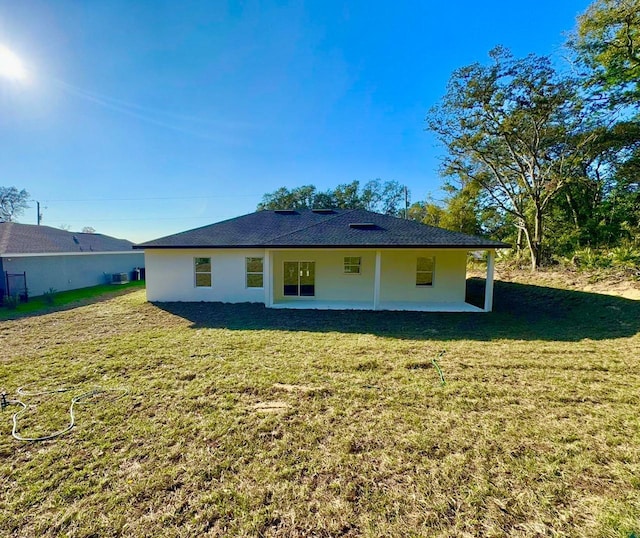 back of property featuring a yard and a patio area