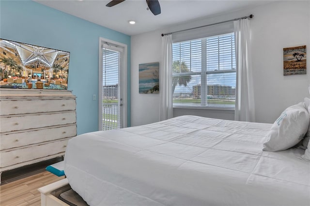 bedroom featuring ceiling fan, access to exterior, and light hardwood / wood-style flooring