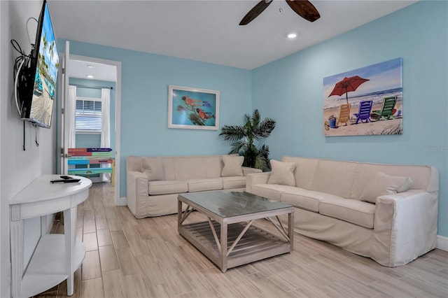 living room featuring ceiling fan and light wood-type flooring