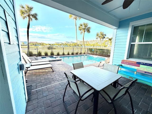 view of pool with ceiling fan and a patio area