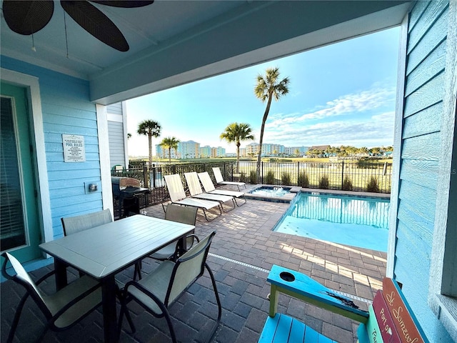 view of pool featuring ceiling fan and a patio