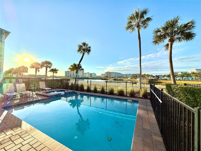 view of swimming pool with an in ground hot tub