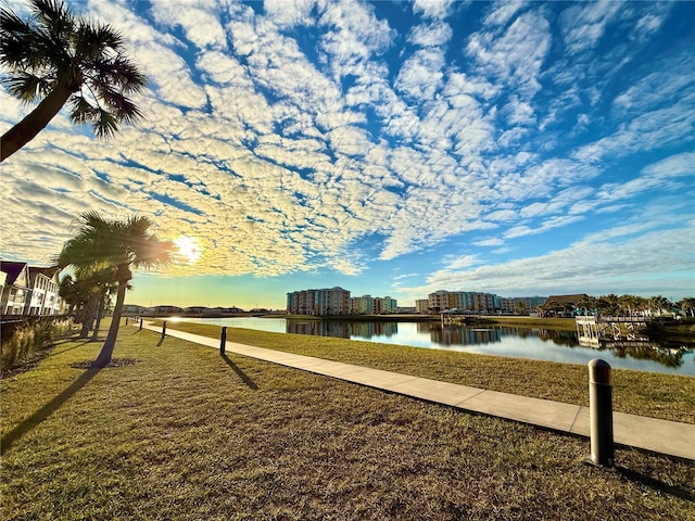 view of community with a water view and a lawn