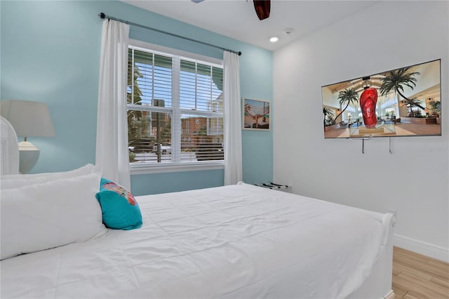 bedroom with ceiling fan and light wood-type flooring