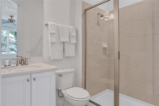 bathroom featuring ceiling fan, an enclosed shower, vanity, and toilet