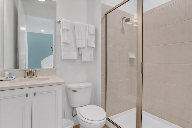 bathroom with toilet, vanity, and walk in shower