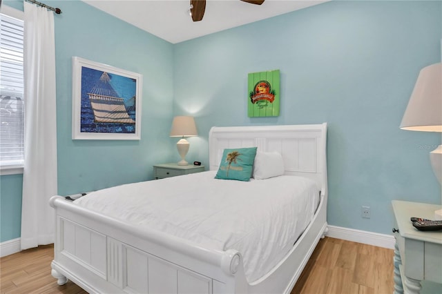 bedroom with ceiling fan and light hardwood / wood-style flooring