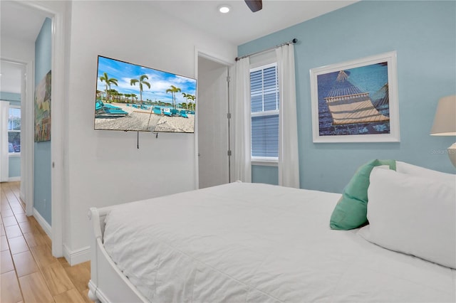 bedroom with ceiling fan and light hardwood / wood-style floors