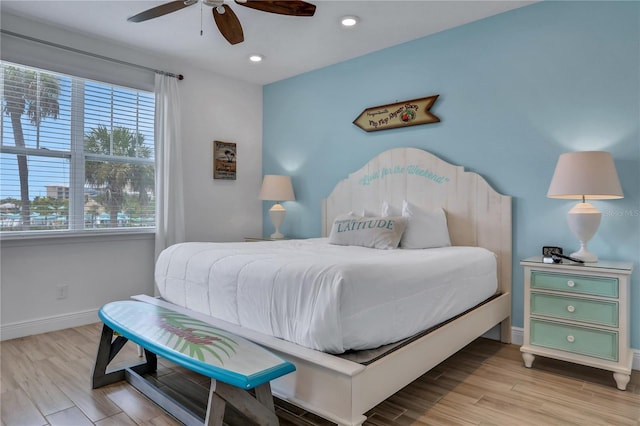 bedroom with ceiling fan and light hardwood / wood-style floors